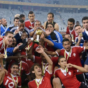Libya team players celebrate with their trophy after winning the African Nations Championship football final match between Ghana and Libya, in Cape Town, on February 1, 2014.   (AFP PHOTO / ALEXANDER JOE)