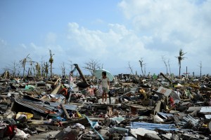 A survivor walks among the debris of houses destroyed by Super Typhoon Haiyan in Tacloban in the eastern Philippine island of Leyte (AFP PHOTO / NOEL CELIS)