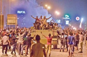 Protesters cheer upon arrival of the Egyptian Security Forces during clashes between ousted president Mohammed Morsi's supporters and anti-Morsi protesters near Egypt's landmark Tahrir Square Saturday.   (AFP Photo) 